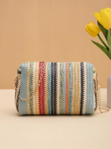 Macro detail of multi-color rainbow straw woven texture and elegant gold chain strap