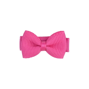 Detailed view of a handmade pink grosgrain ribbon bow hair clip with textured fabric