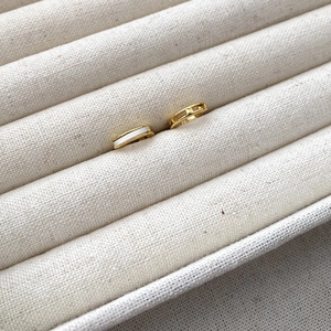 Macro view of gold S925 sterling silver earrings with white mother-of-pearl inlay