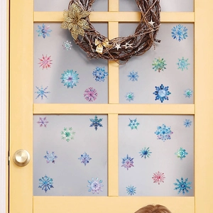 Colorful snowflake window stickers in blue and pink for festive glass door decoration