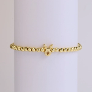 18k gold-plated brass Taurus zodiac bead bracelet with elastic cord on display