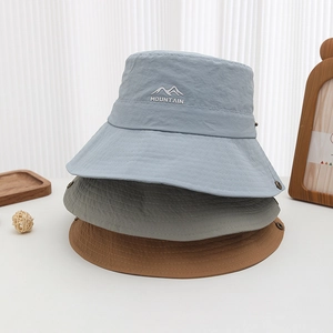 Outdoor adjustable kids sun hats in light blue, sage green and mustard with mountain embroidery