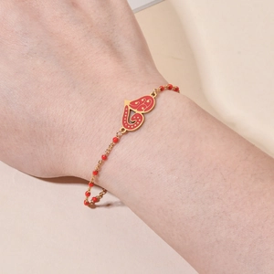 Bohemian gold stainless steel bracelet featuring a red enamel heart pendant with red beads