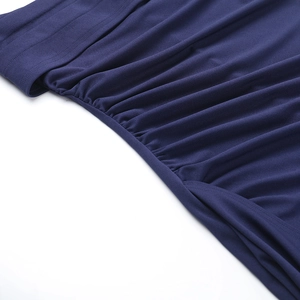 Close-up of the fine stitching and navy blue knitted fabric on a side slit dress