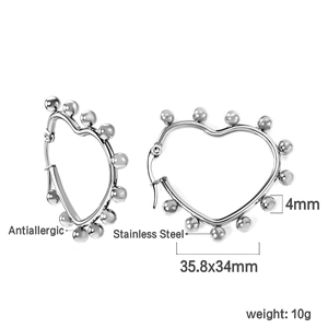 Detail of silver heart-shaped stainless steel hoop earrings with bead trim and size info