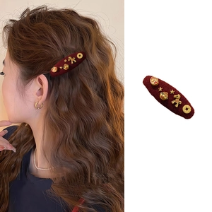 Vintage red velvet hair clip with golden pony and lucky charms for women's side styling