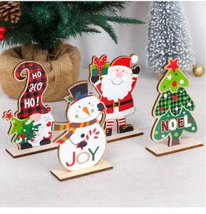 Detailed view of wooden Christmas ornaments featuring Santa and Snowman desk decor