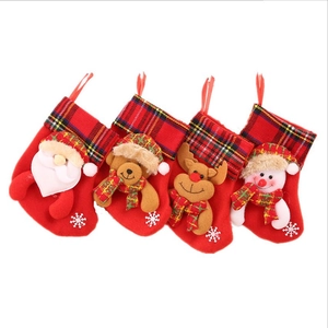 Set of four red Christmas stockings with plush Santa, reindeer, bear, and snowman figurines