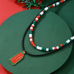Close-up of Merry Christmas pendant with red, green and white festive glass beads