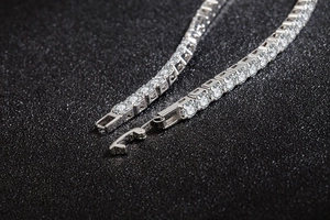 Detailed macro view of sparkling silver-tone tennis bracelet with claw-set cubic zirconia