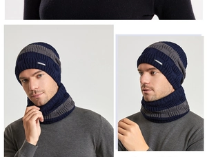 Detail of dark blue and grey striped knitted beanie and neck warmer set with logo tag