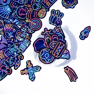 Macro shot of 50pcs holographic neon vinyl stickers featuring galaxy and food icons