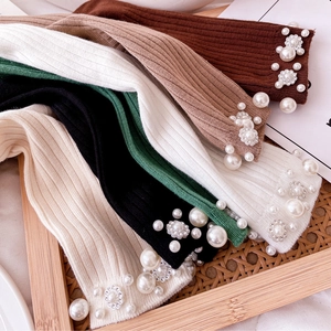 Five pairs of pearl and flower embellished knitted slouch socks in five earthy tones
