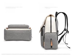 Detail view of the durable fabric base and side profile of the cream grey diaper backpack