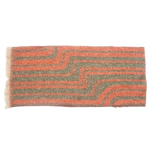 Close-up of winter scarf with red and green wave patterns and fringed tassel details
