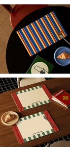 Detail of waterproof leather placemat with striped design and round happy leather tag