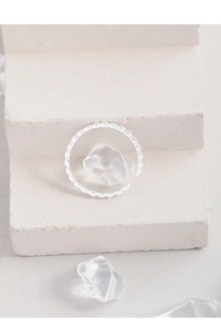 Close-up of S925 sterling silver wavy beaded open ring on a textured stone surface