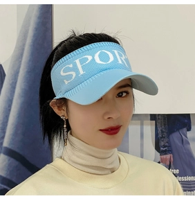 Close-up of light blue knitted sun visor hat featuring a bold white SPORT letter print