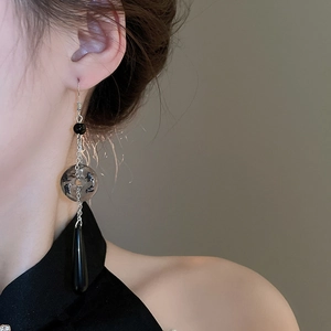 Detail of a New Chinese ink-style water drop earring with calligraphy on clear ring