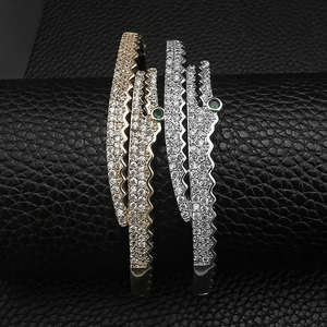 Close-up of crocodile bracelets with gold and silver plating and sparkling white zircon stones