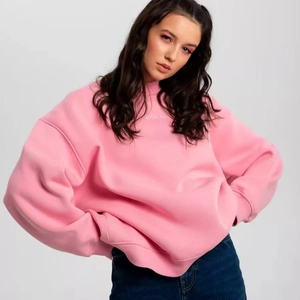 Detail of pink oversized sweatshirt showing the premium thick fabric and soft texture