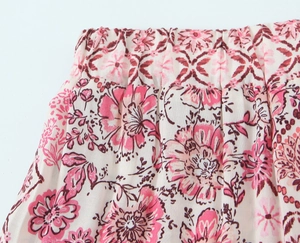 Close-up of elastic ruffled waist and floral print on pink casual skirt fabric