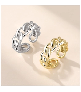 Close-up of gold and silver multi-layer twisted rope rings with adjustable open band