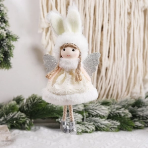 Plush Christmas angel ornament with rabbit ears and glitter wings on snowy pine background