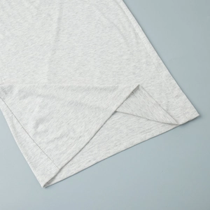 Close-up of the light gray marl fabric texture and double-needle hem on lounge trousers