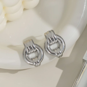 Detailed view of silver hoop earrings with interlocking link design in polished titanium steel