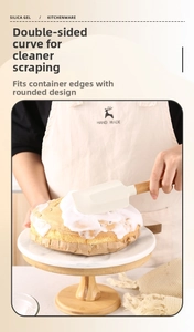 Detail of cream silicone spatula with beech wood handle for smooth cake icing