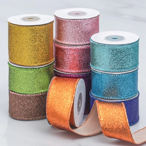 Close-up of sparkling glitter ribbon rolls in various metallic colors for DIY Christmas decor