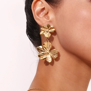 Close-up of a model wearing double-layered 18K gold plated floral drop earrings