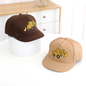 Detail of kids baseball caps featuring embroidered yellow excavator on brown and khaki fabric