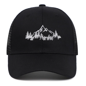 Close-up of white mountain forest embroidery on black trucker hat with mesh panels