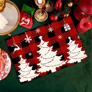 Detailed view of red and black buffalo plaid Christmas placemat with reindeer and tree patterns