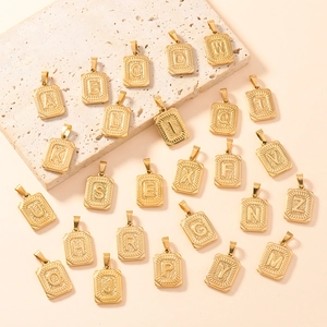 Detailed view of 26 alphabet square charms in gold stainless steel for DIY jewelry