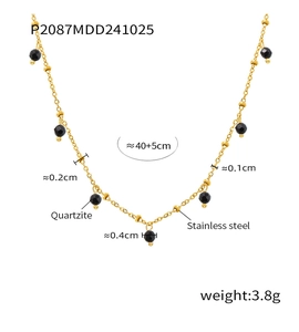 Detail of 18K gold plated stainless steel necklace with black faceted quartzite beads