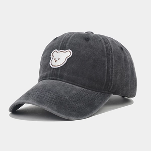 Detail of cute white bear embroidery on dark grey washed cotton baseball cap