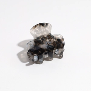 Detail of medium hair claw clip with black and white marble pattern made of acetate