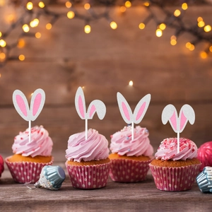 Easter party cupcakes with white glitter rabbit ear toppers and pink interior accents