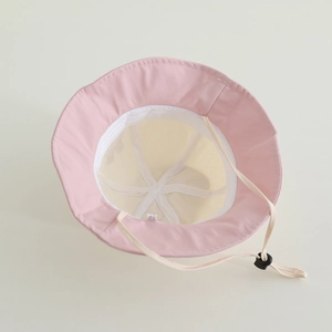 Detail of baby sun hat with adjustable beige chin strap and soft pink cotton lining