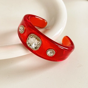 Close-up of vintage resin cuff bracelet with three-stone crystals and pave setting
