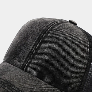 Close-up of washed cotton texture and breathable mesh splicing on ponytail baseball cap