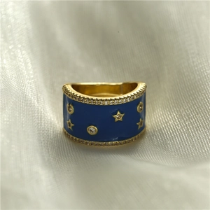 Golden wide ring with blue enamel and star patterns featuring micro-set cubic zirconia