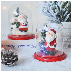 Detail of LED Christmas glass dome with Santa Claus, snowman and tiny pine trees