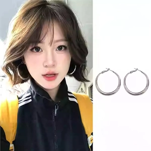 Detailed view of silver hoop earrings showing both model wear and still life product shot