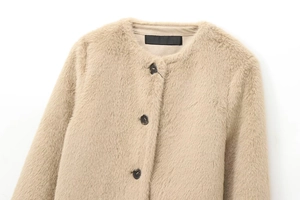 Close-up of khaki faux fur jacket featuring plush texture and dark resin buttons
