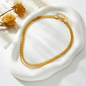 Double-layered gold-plated stainless steel Cuban chain necklace on a white display tray