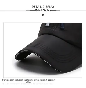 Detail of black sports cap brim with parallel stitching and printed sports lettering